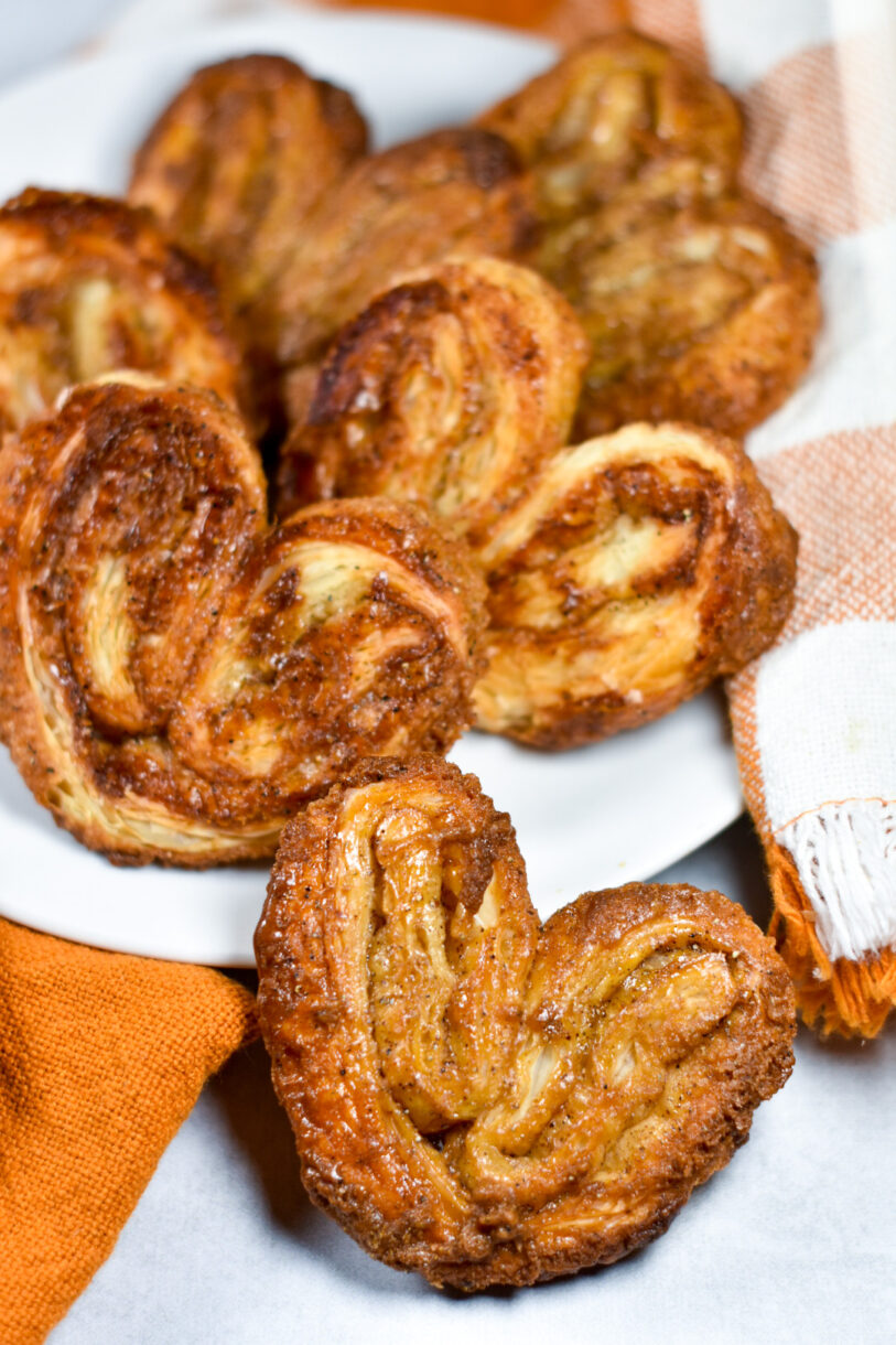 Brown sugar, orange, and cardamom palmiers on a white plate