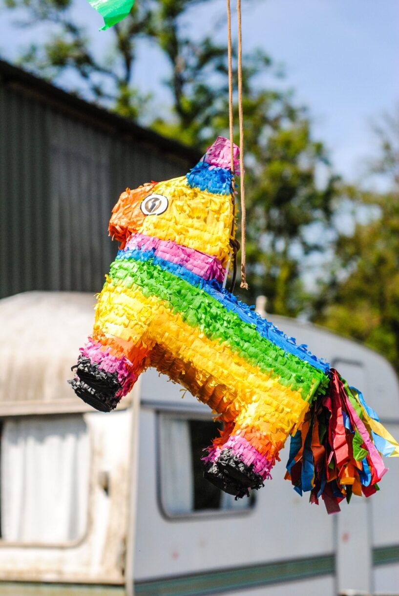 Rainbow donkey pinata at a party