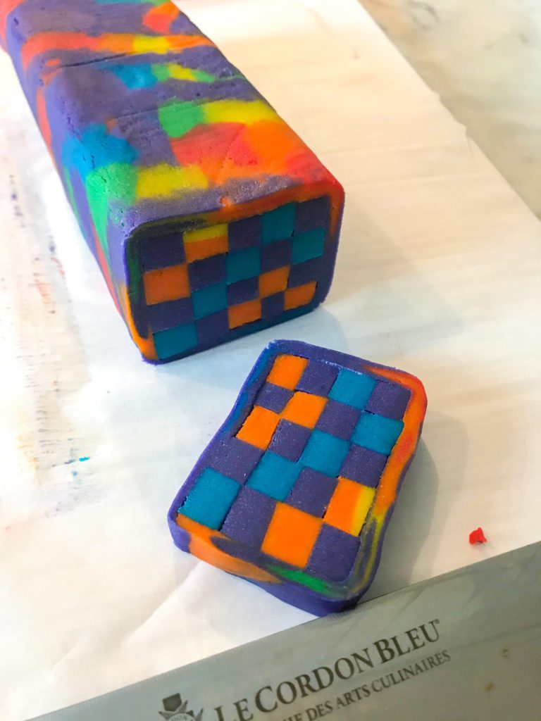 Slicing rainbow checkerboard cookies