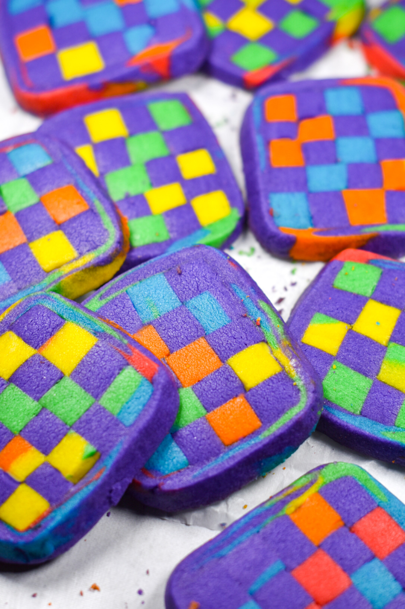 Close up shot of multicolored checkerboard cookies on a white background