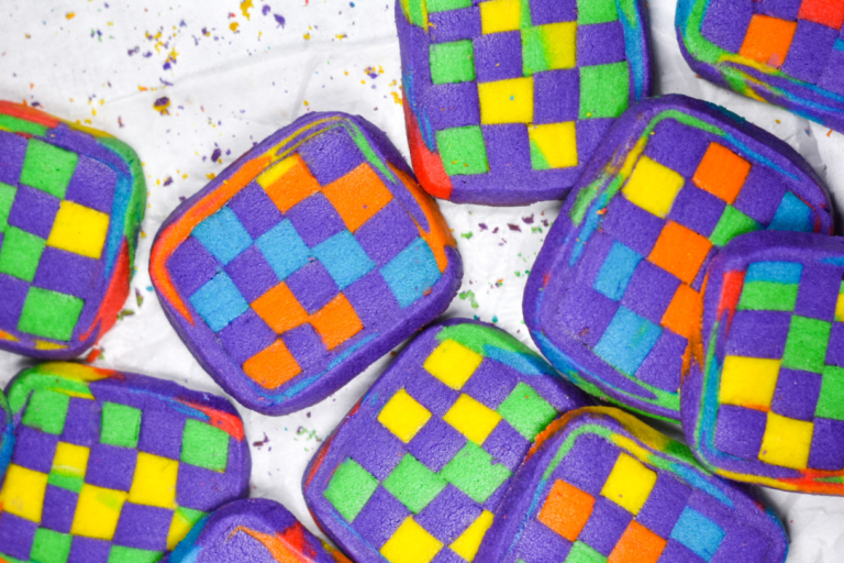 Checkerboard cookies on a white background, with crumbs