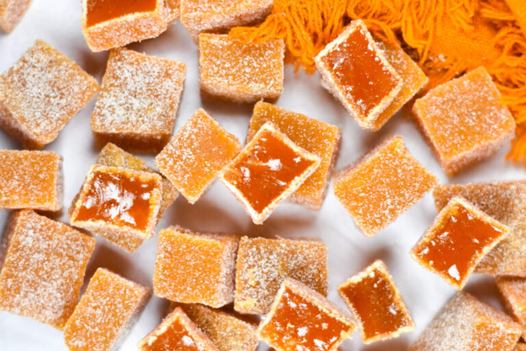 Carrot candy and an orange tea towel on a white background