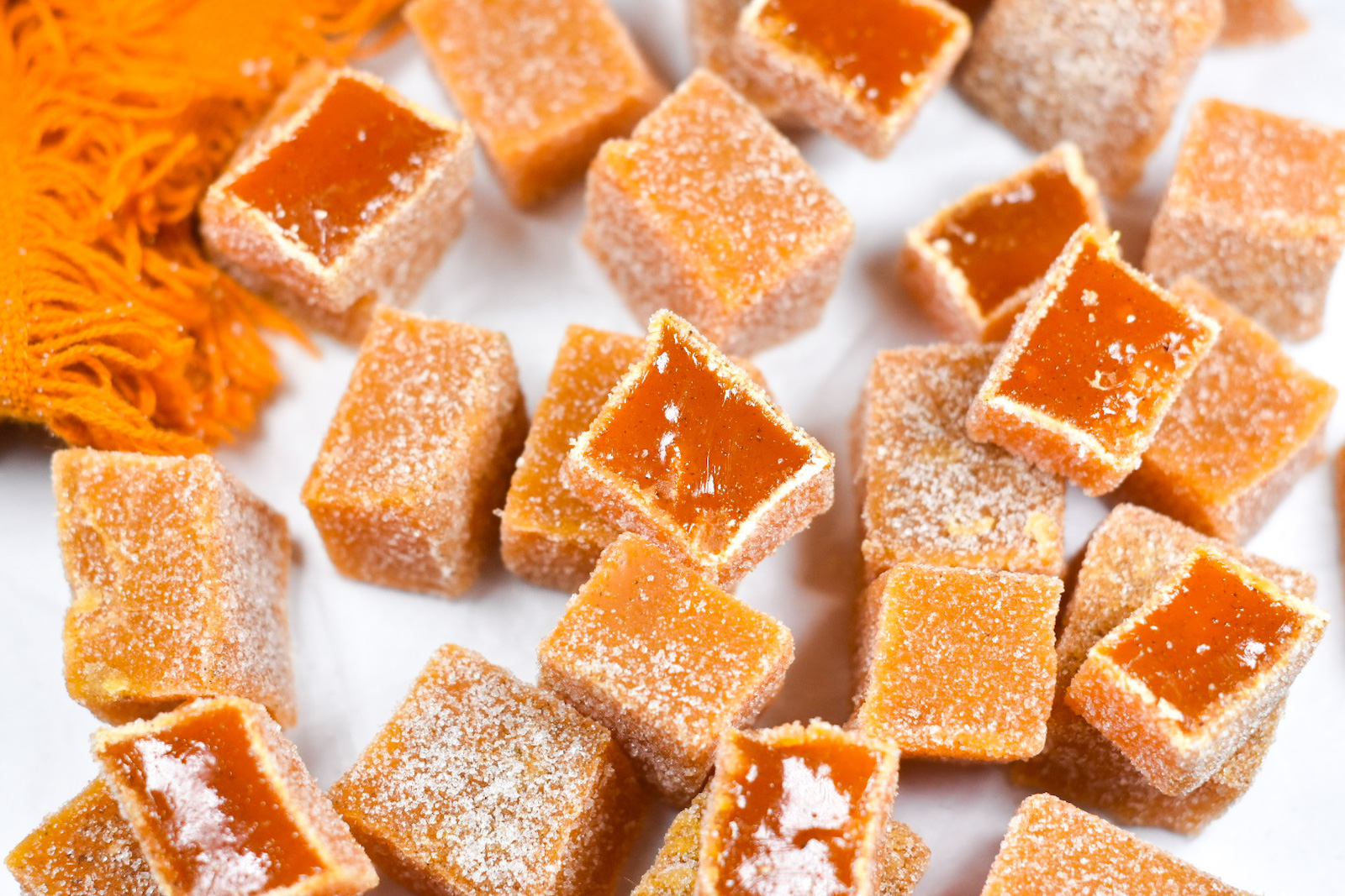 carrot ginger candies arranged on a white surface