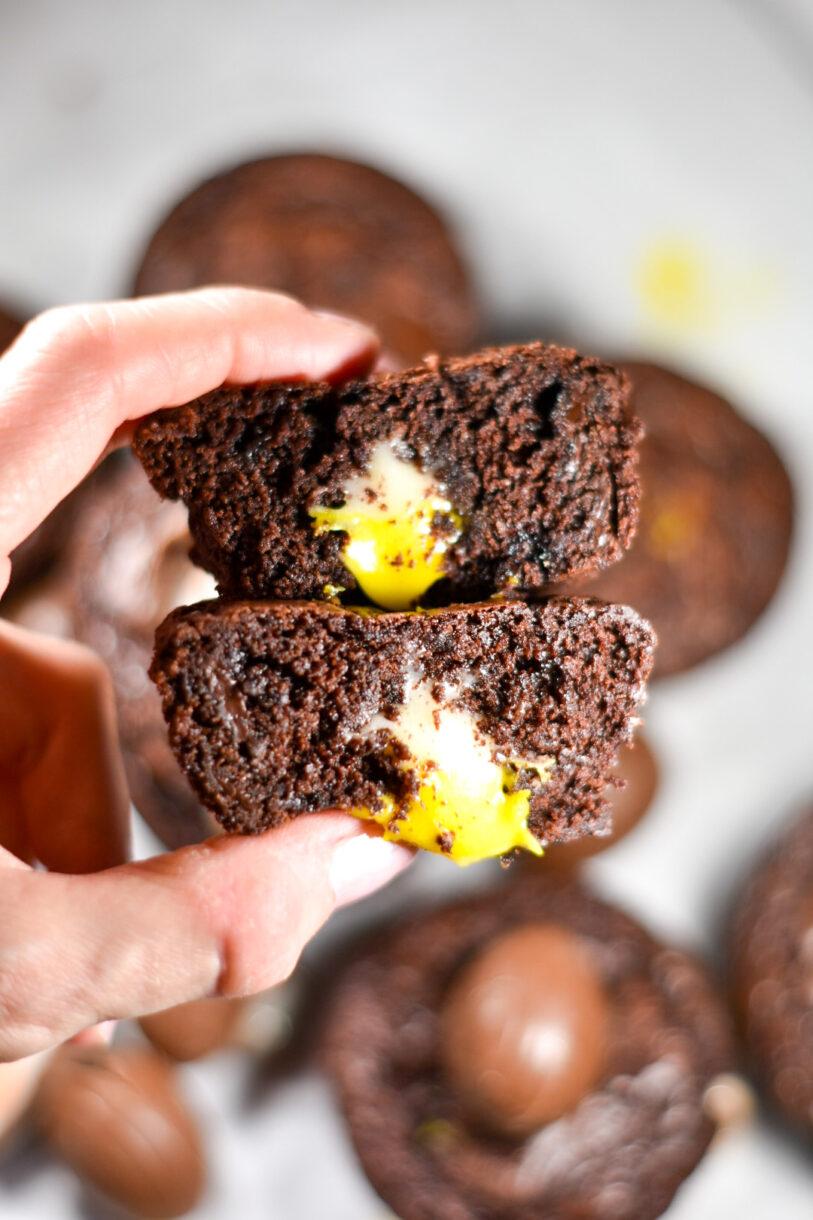 Hand holding two creme egg brownie cups