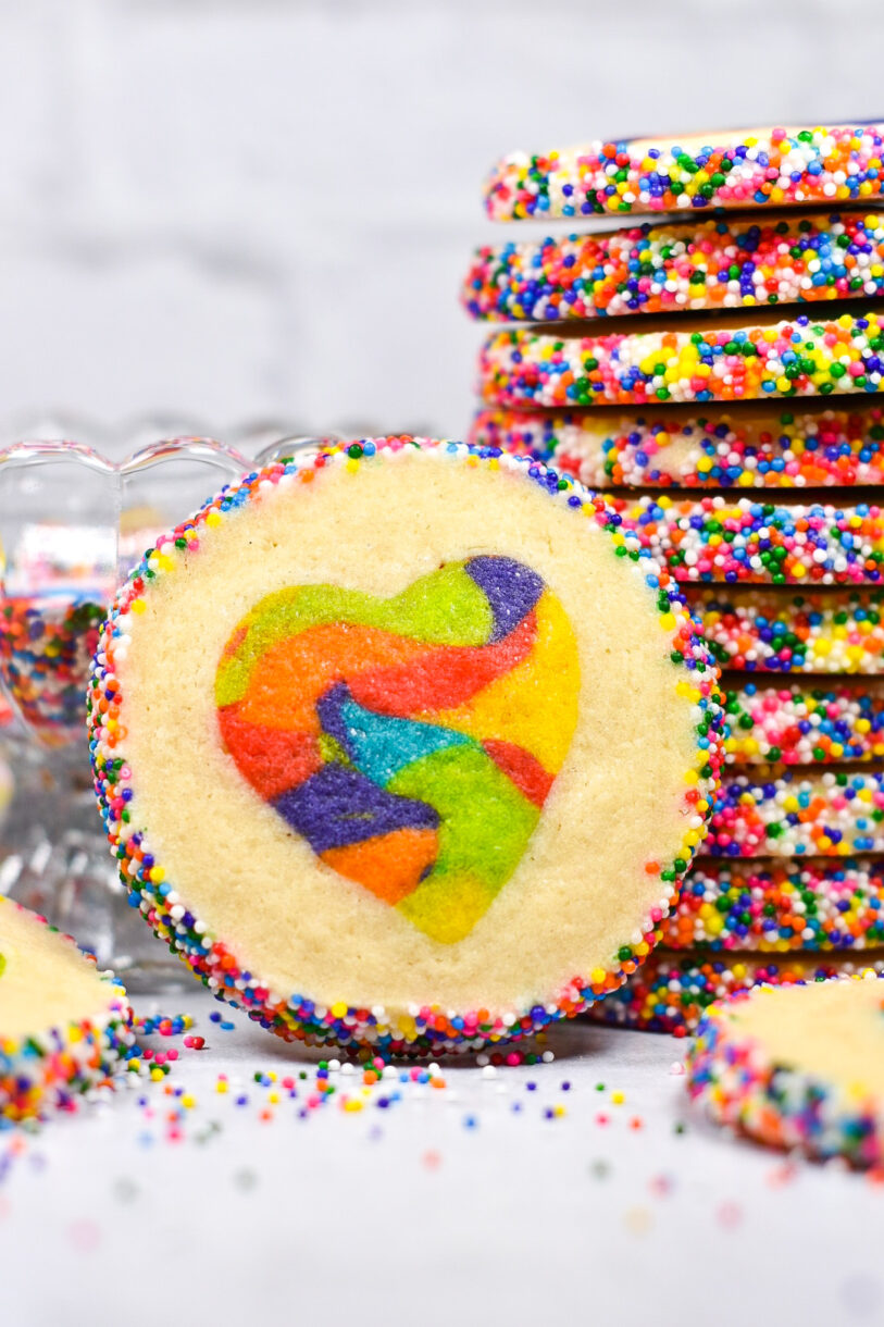 Horizontal shot of a heart cookie, with stack of cookies in the background