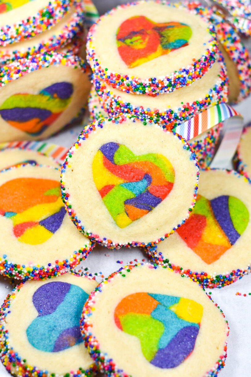 Rainbow Slice and Bake Heart Cookies scattered on a white surface