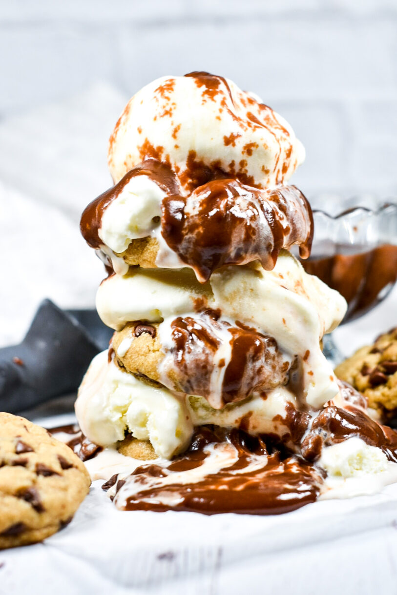 Chocolate chip cookies layered with vanilla ice cream, and melted chocolate dripping down the sides