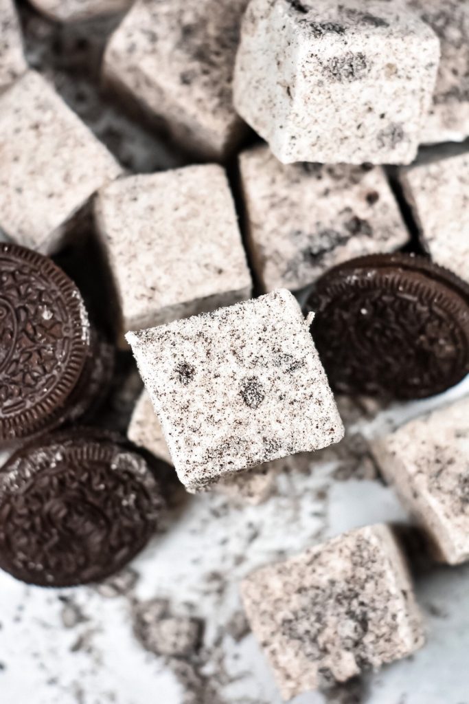a stack of Oreo marshmallows on a white surface with Oreo cookies
