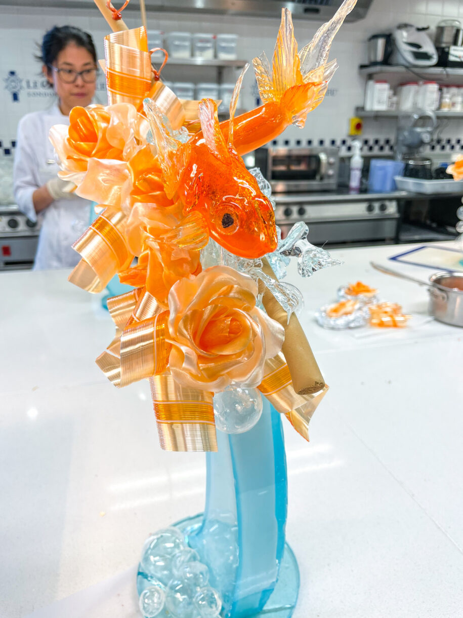 A sugar sculpture made at Le Cordon Bleu London, with student chef in the background