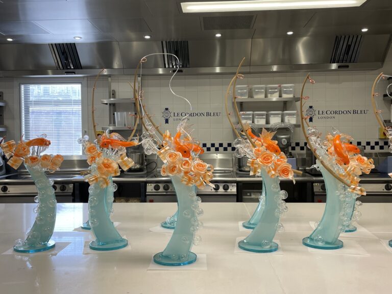 Kitchen at Le Cordon Bleu London, with students' completed sculptures displayed on the countertop
