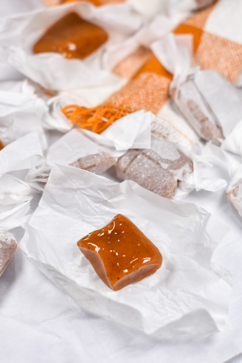 A square of pumpkin caramel on a white wrapper