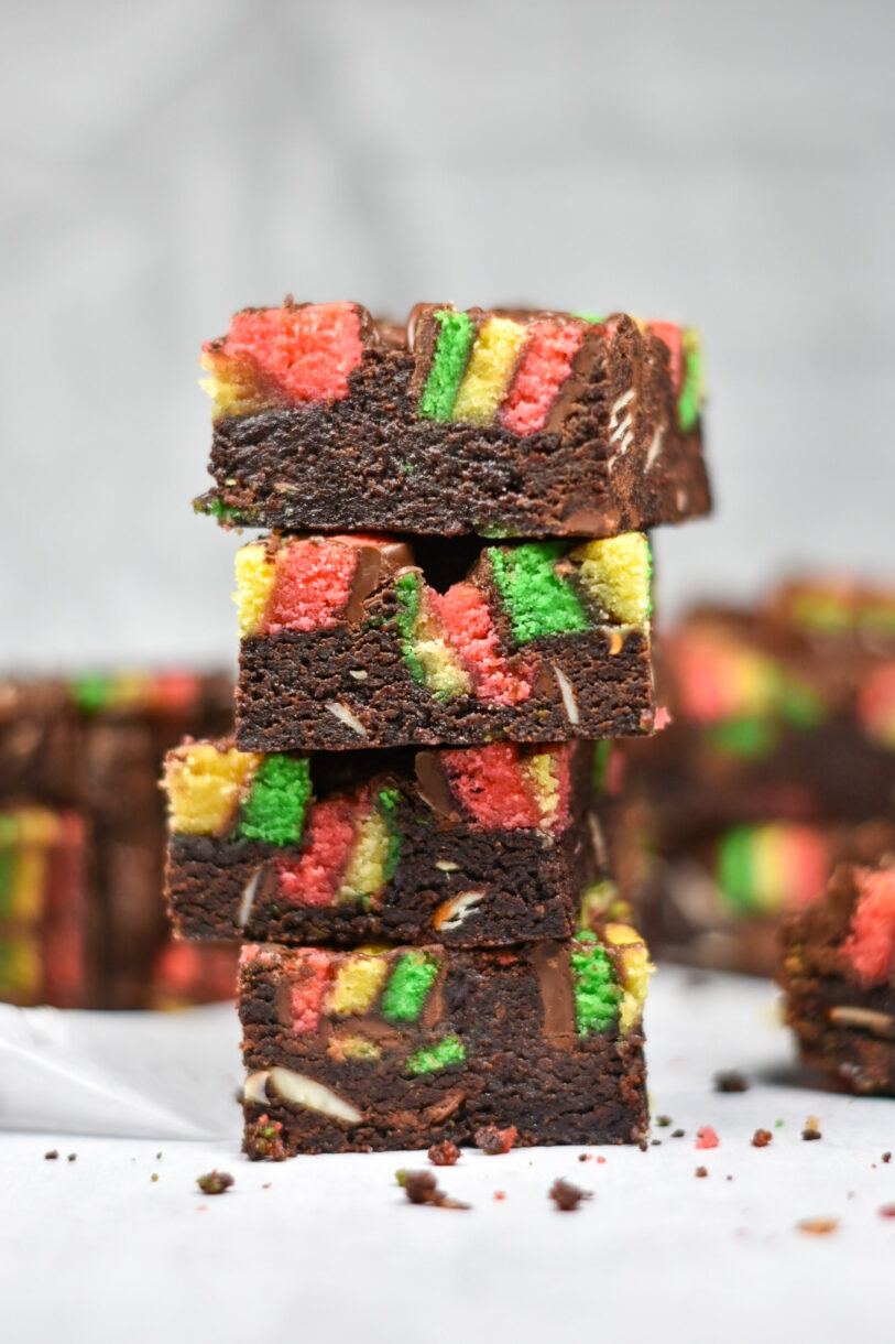 A vertical shot of a stack of four Italian rainbow brownies