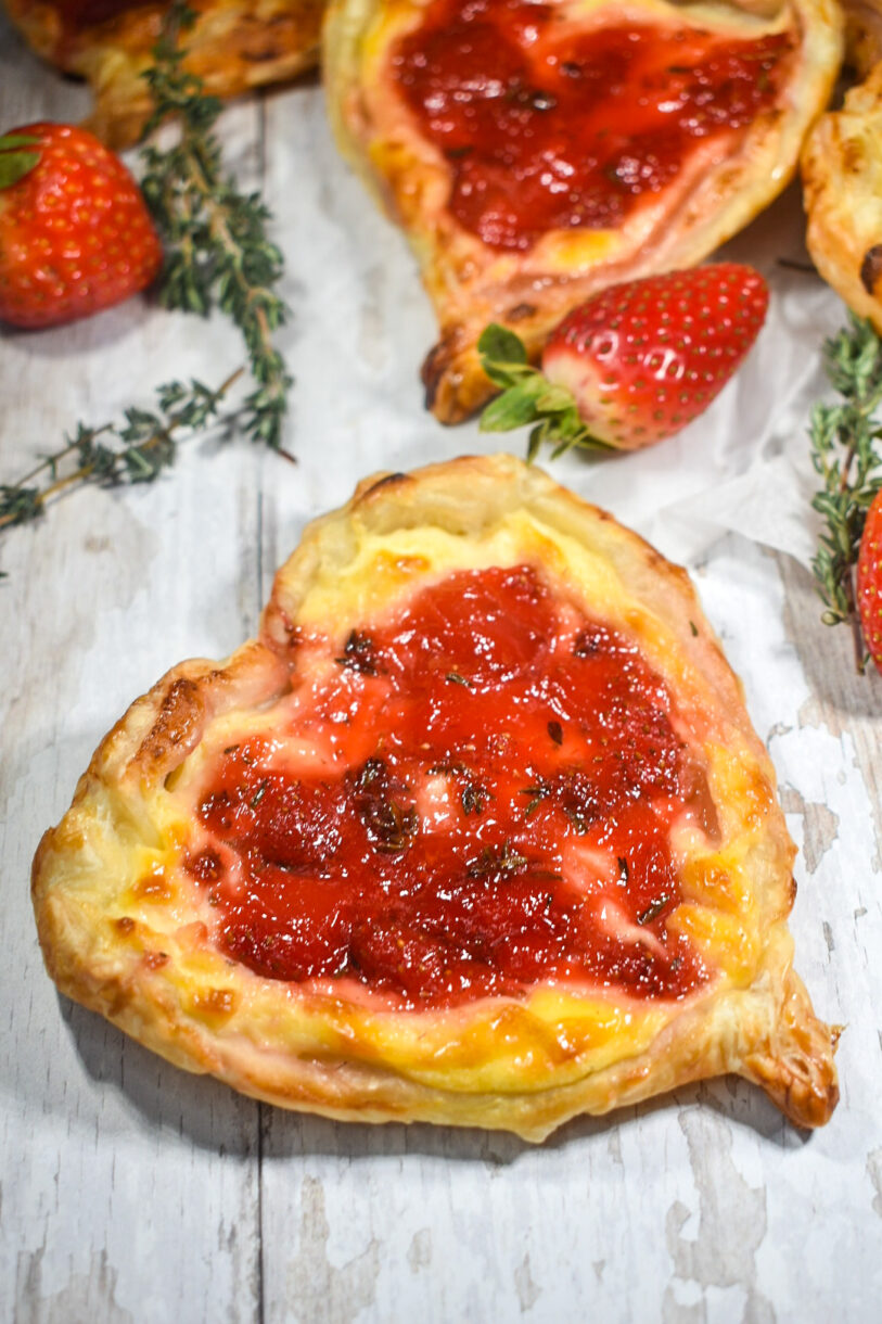 A heart shaped pastry filled with strawberry jam