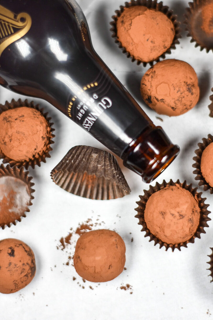 Guinness and dark chocolate truffles and an open bottle of beer, plus an empty truffle cup