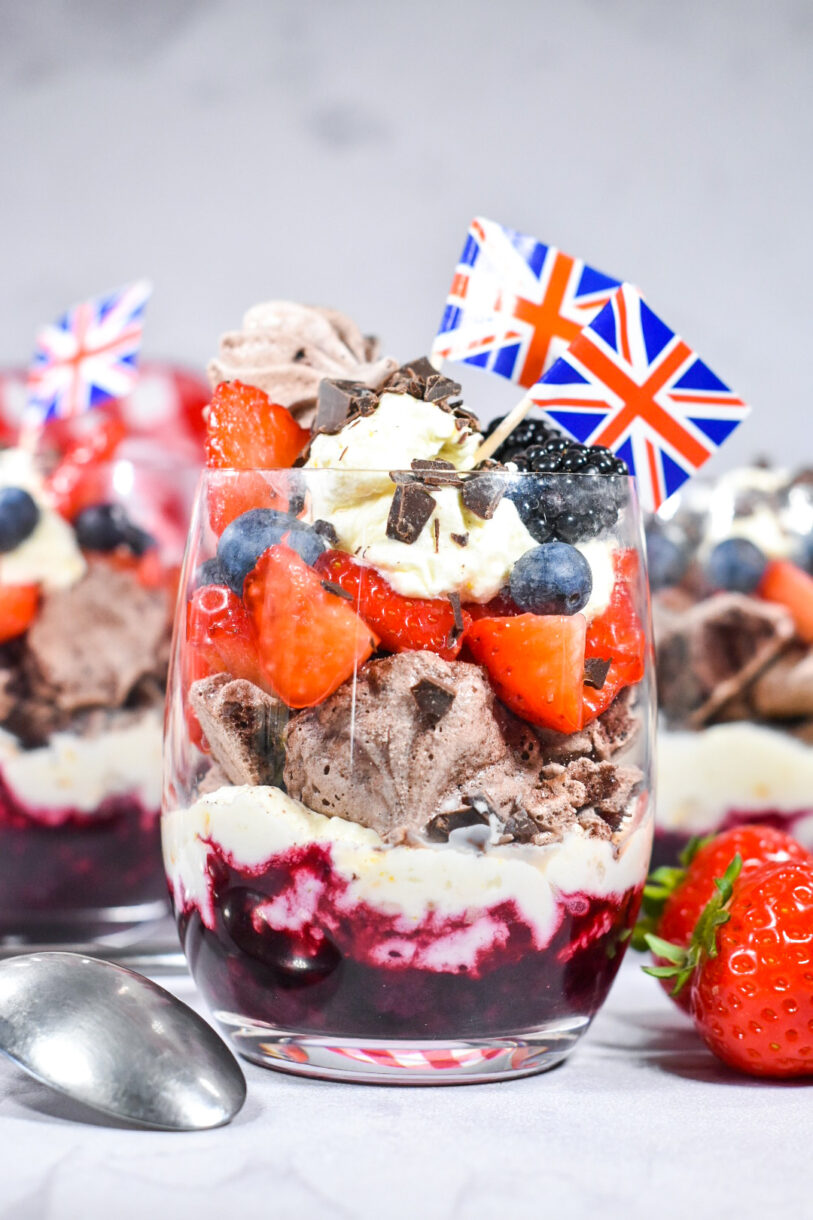 Triple Berry Eton Mess with Chocolate Meringue, layered in a glass with miniature UK flags
