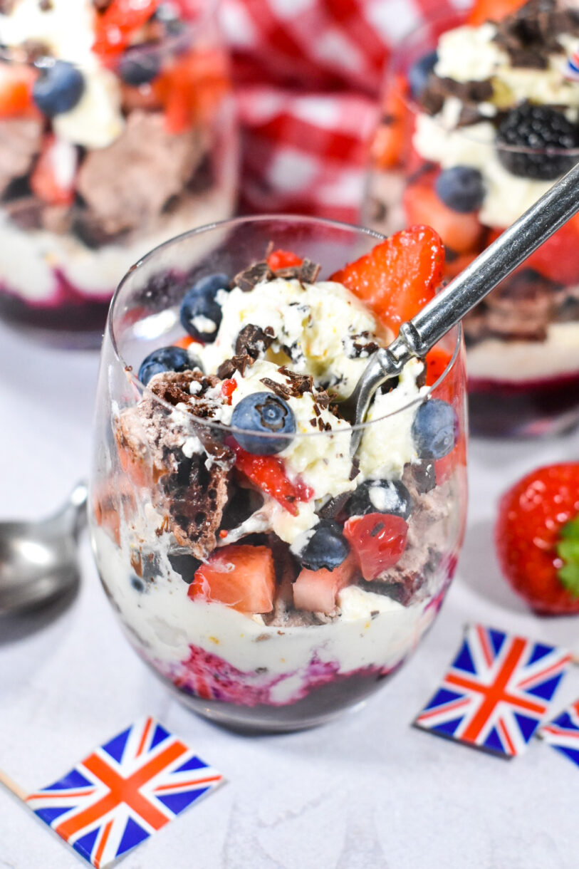 Looking down into a partially eaten parfait, with minature British flags nearby