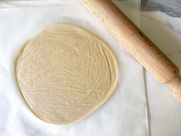 White dough rolled between parchment