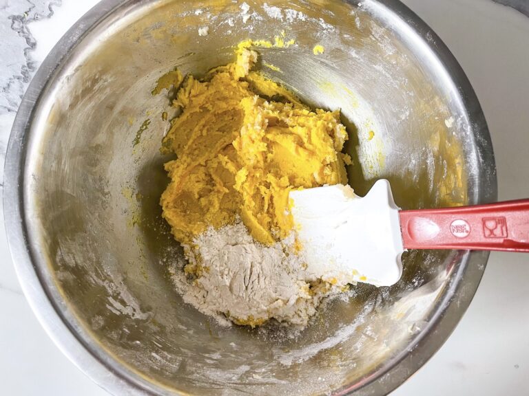 Adding flour to yellow dough mixture for consistency