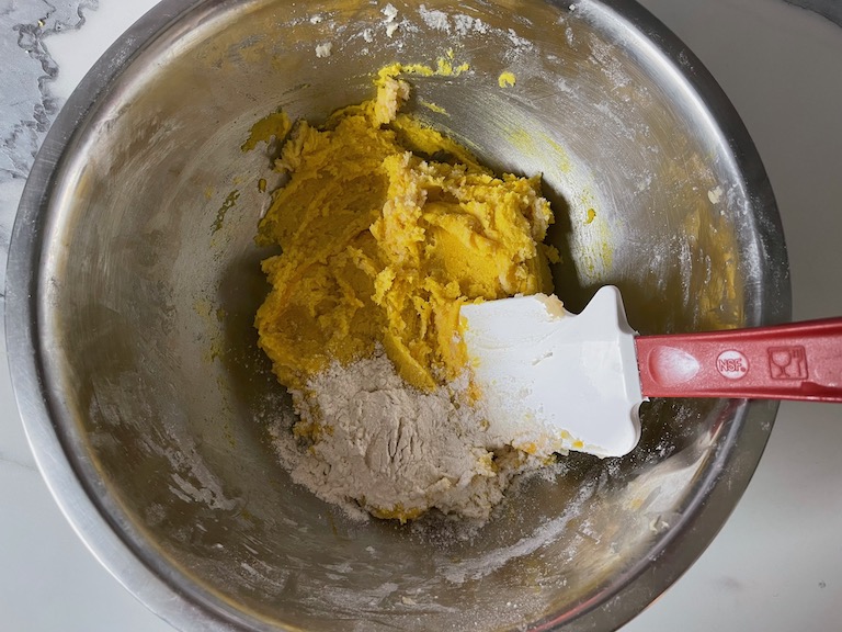 Flour, dough, and spatula in a bowl