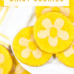 Made with lemon juice, zest, and oil, this spring-inspired lemon daisy slice and bake cookie recipe features a vibrant yellow color, zesty lemon flavor, and a fun cut out flower surprise in the middle!