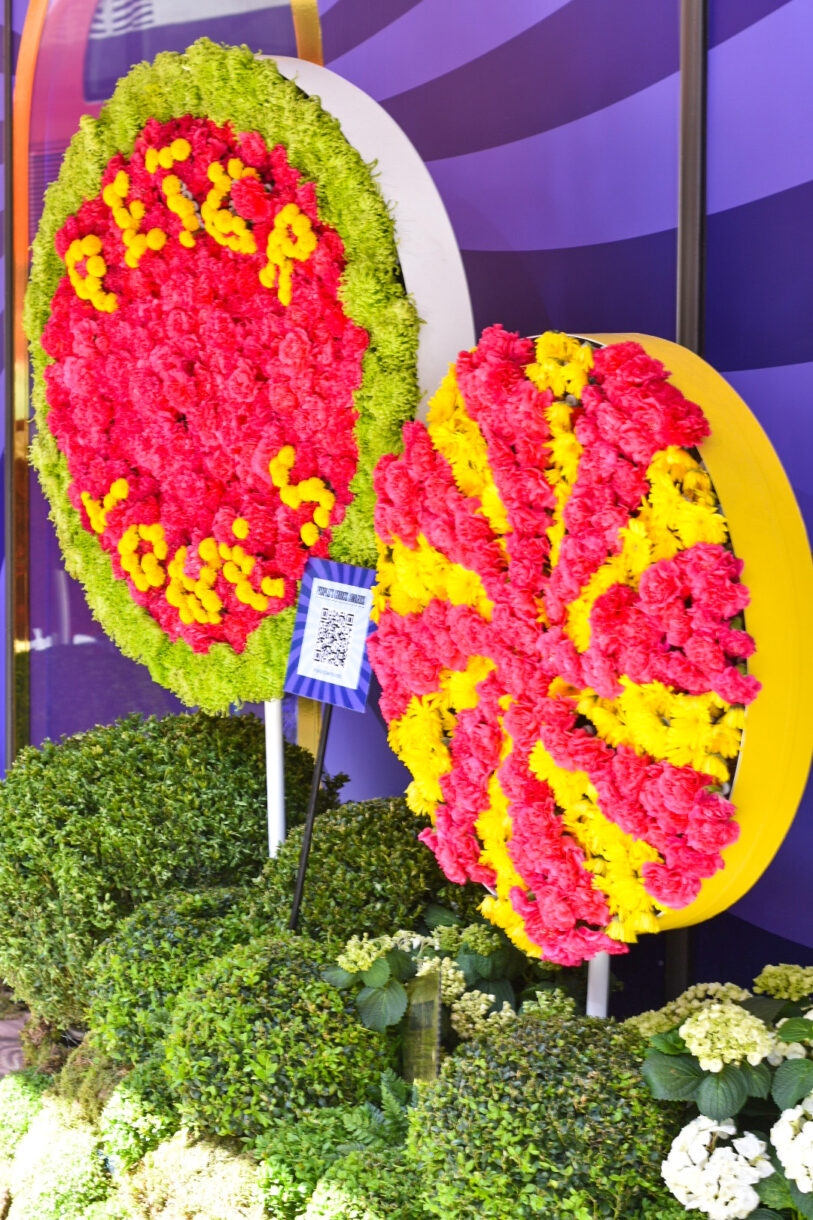 Giant lollipops made out of flowers in pink, yellow, and green