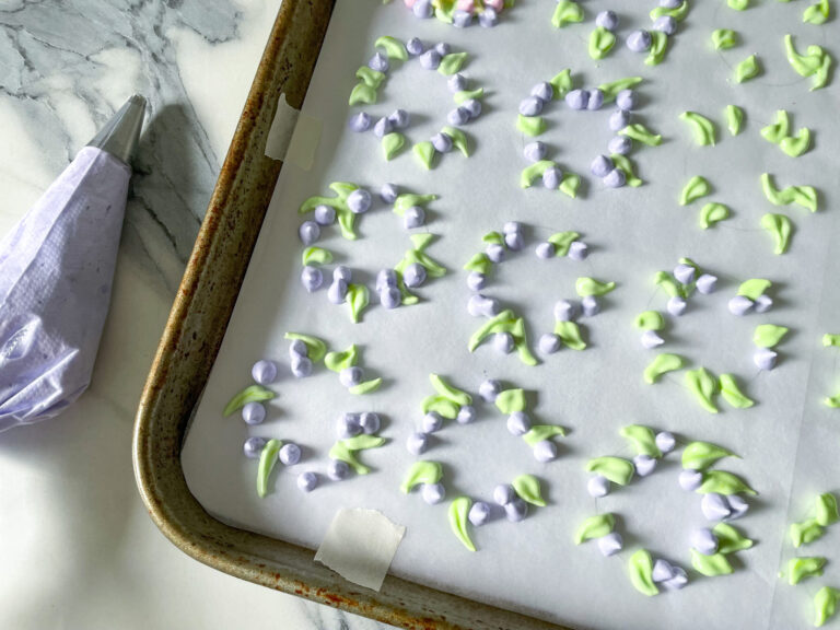 Piping meringue cookies onto a tray to make this meringue cookies recipe