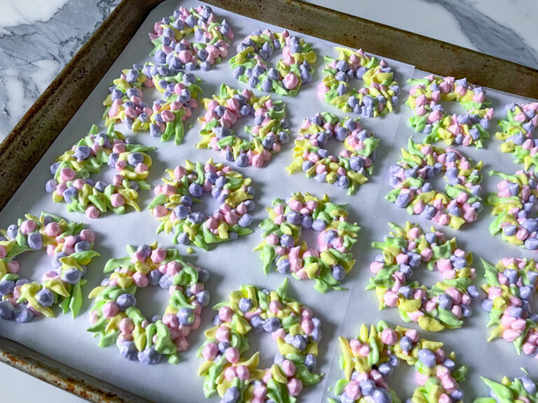 Meringue wreaths piped on a lined tray to make this meringue cookies recipe