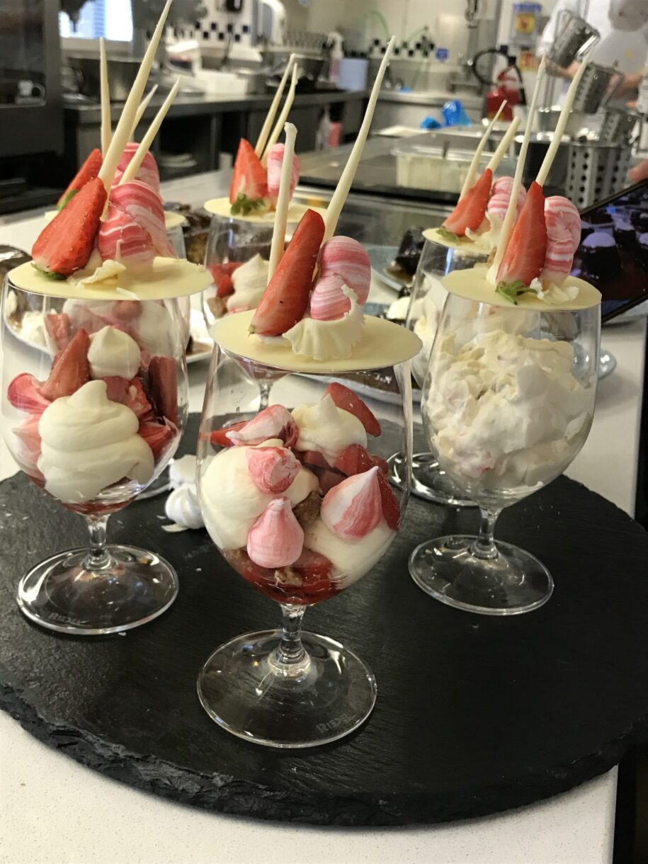Parfait glasses with white and pink Eton mess, during a demonstration at Le Cordon Bleu London