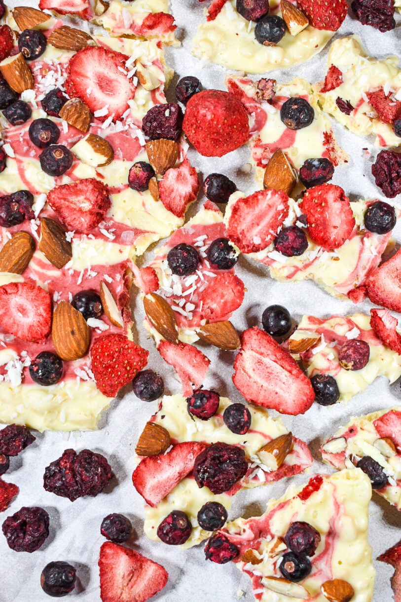 Closeup shot of white chocolate bark with sttrawberries, blueberries, coconut, and almonds