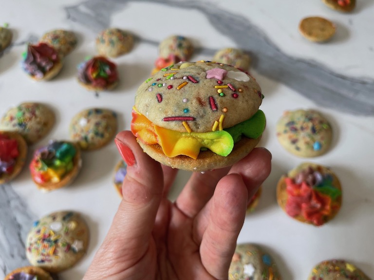 hand holding a rainbow whoopie pie