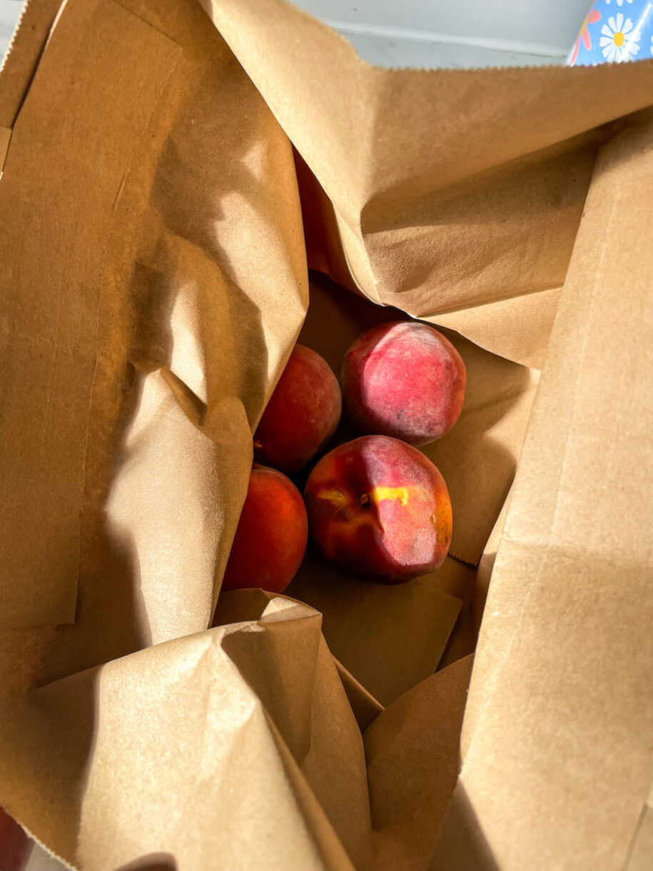 Peaches in a brown paper bag