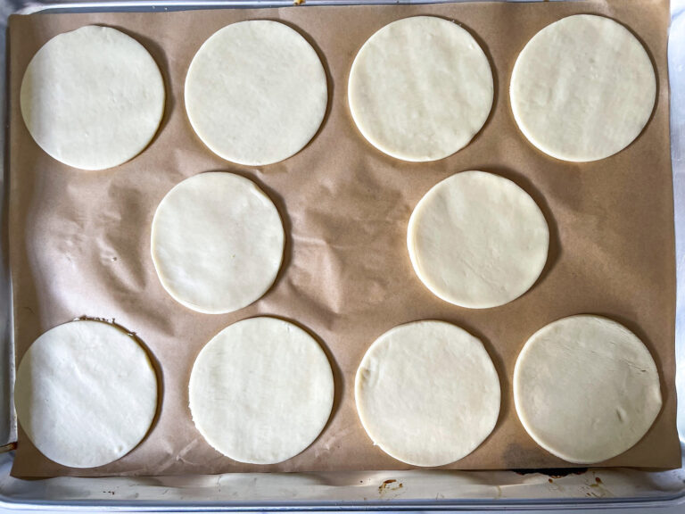 Discs of unbaked pastry on a tray