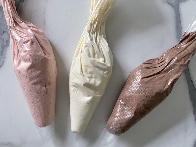 Piping bags of vanilla, chocolate and strawberry buttercream