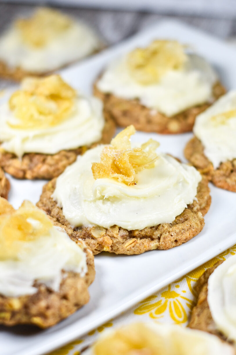 Parsnip cookies on a white plate, with yellow dish towel underneath