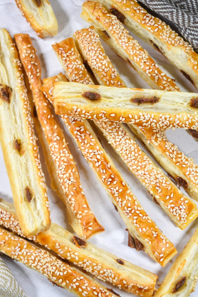 Puff pastry anchovy sticks on a white background