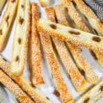 Puff pastry anchovy sticks appetizer on a white background