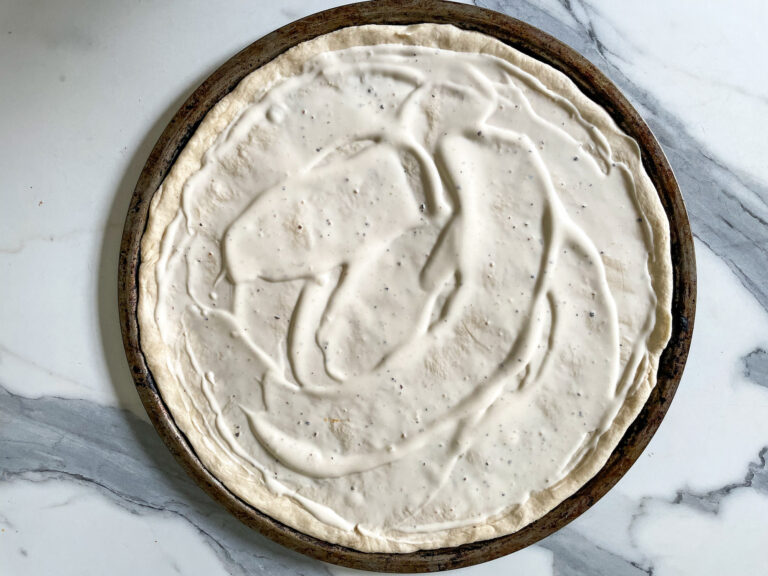 Pizza dough spread with blue cheese dressing