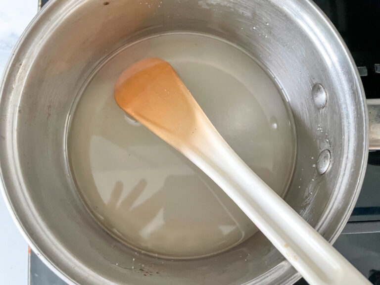 Saucepan with simple syrup, accompanied by plastic spoon