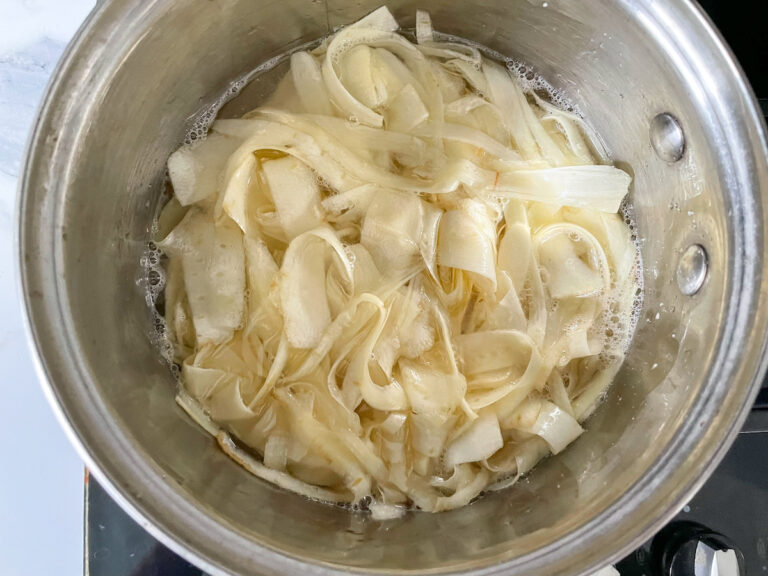 Strips of raw parsnip in a saucepan
