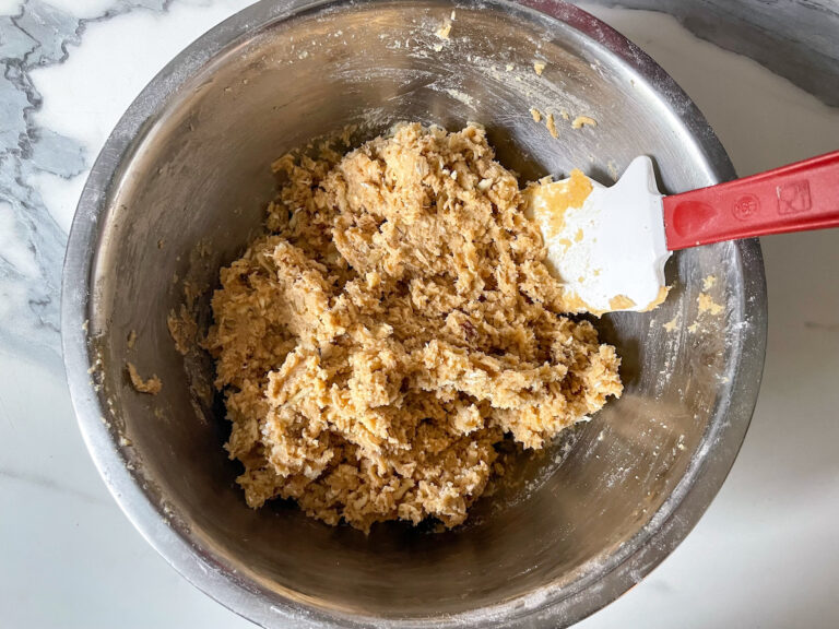 Bowl of parsnip oatmeal cokie dough, being stirred by a rubber spatula