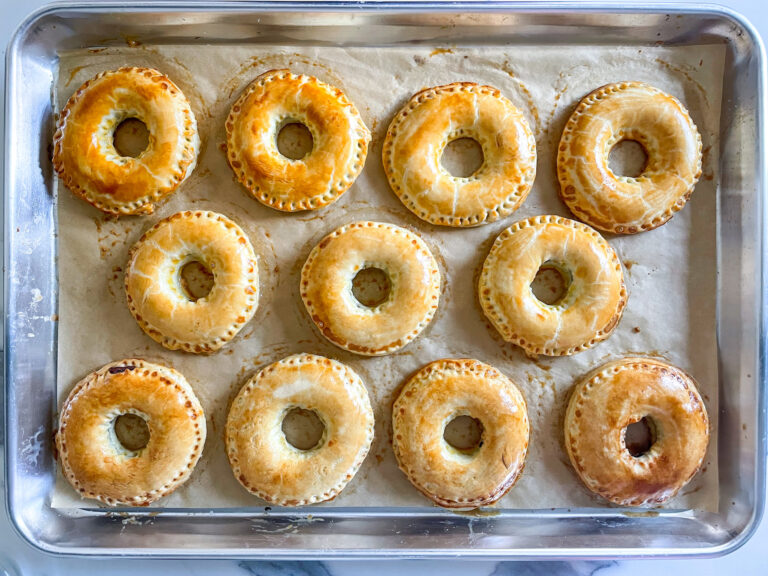 Ring shaped pastries on a parchment lined tray
