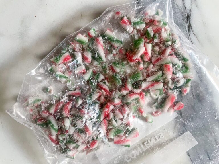 Crushed candy canes in a bag on marble countertop