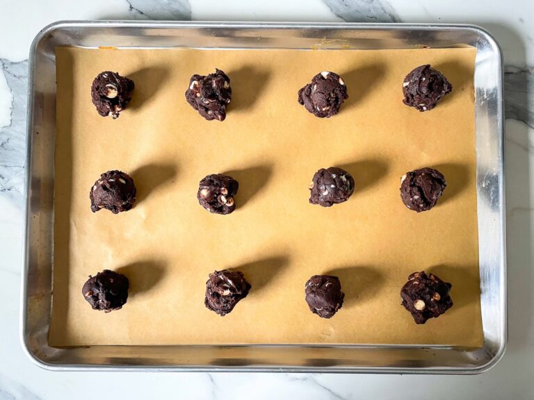 Balls of cookie dough on a baking tray