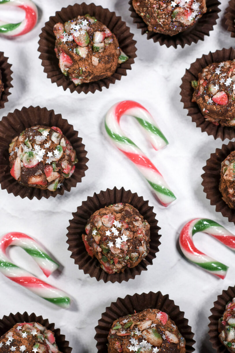 Christmas truffle recipe and crushed candy canes on white surface
