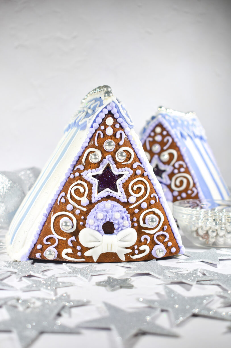 Gingerbread houses decorated with purple and white icing and fondant