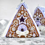 Gingerbread houses and silver stars on white background