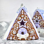 Gingerbread houses on a white surface with silver stars
