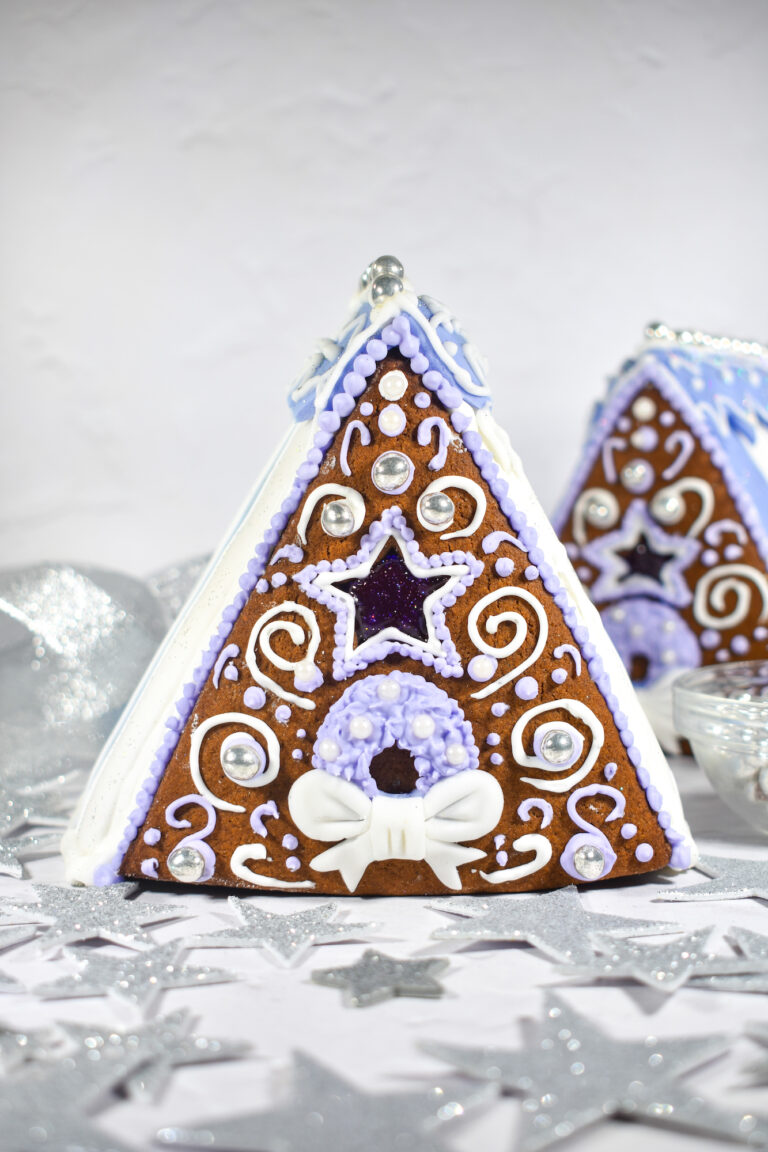 Gingerbread houses on a white surface with silver stars