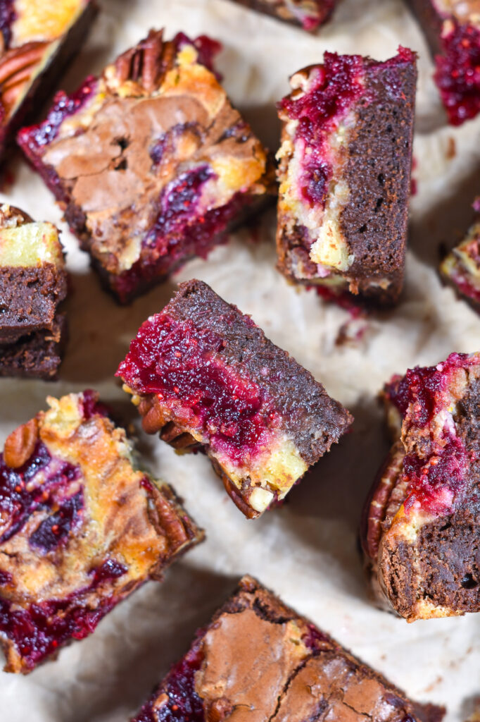 Brie and cranberry brownies on a sheet of parchment