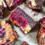 Brie and cranberry brownies on a sheet of parchment